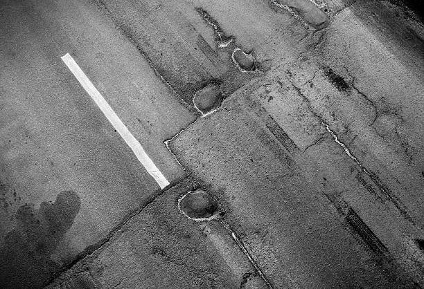 istock Road marking. White line on old asphalt 177748438