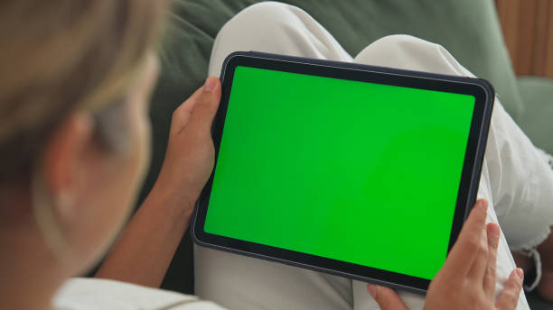 istock Woman tap tablet green screen. Horizontal chroma key display. Person click pad. 1777492261