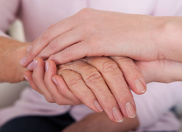 istock Young Woman Holding Senior Woman's Hand 177749254