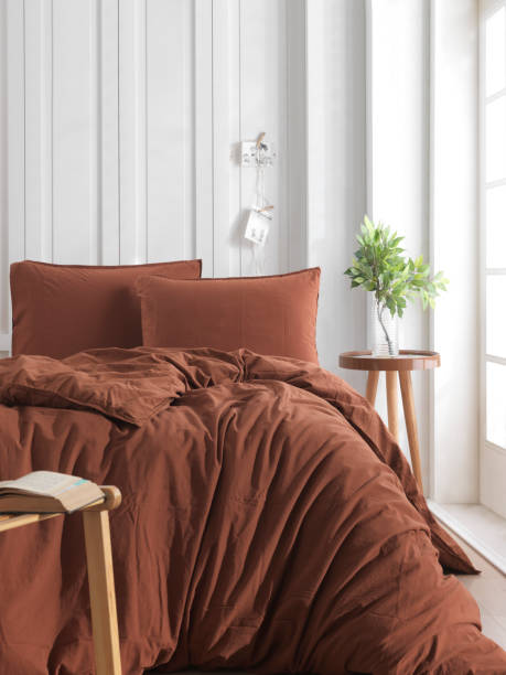 istock Wooden framed comfortable bed with many pillows, blanket 1777493233
