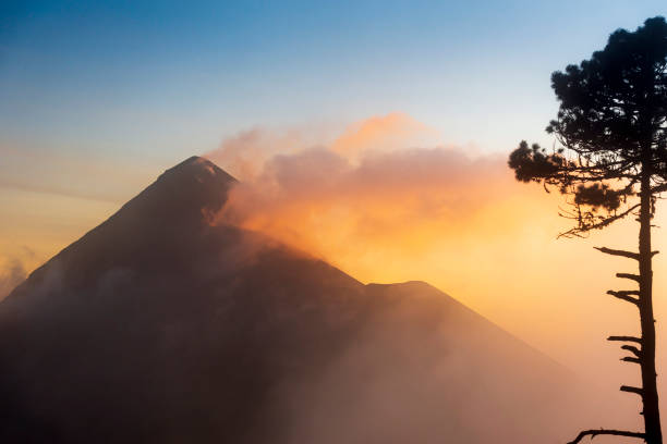Fuego volcano (Volcan de Fuego) at sunset with smoke and cloud seen from Acatenango volcano