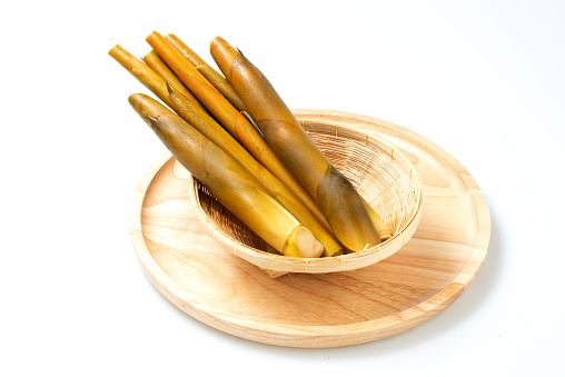 Fres bamboo shoot isolated on white background. Bamboo sprout in plate, asian nature food. Spring vegetable for vegan, organic nutrition and vitamin.