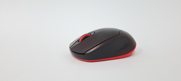 Black wireless minimalist mouse for laptop on the black background. Modern technology device.