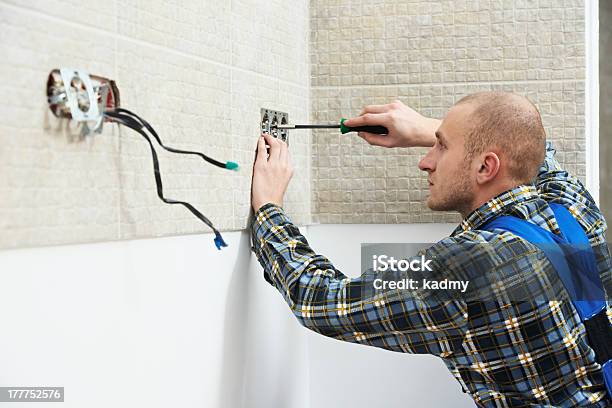 Electrician Installing Wall Outlets Stock Photo - Download Image Now - Adult, Blue-collar Worker, Boarding