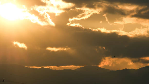 istock Beautiful dramatic sky with clouds at sunset or sunrise. Sunset sky at dusk in the evening with natural sky background with golden orange clouds. 1777542435