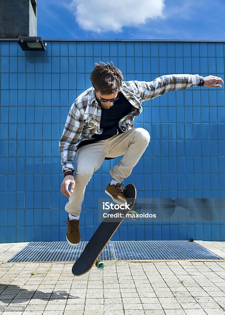 Skateboarder Skateboarder jumping on skateboard Activity Stock Photo