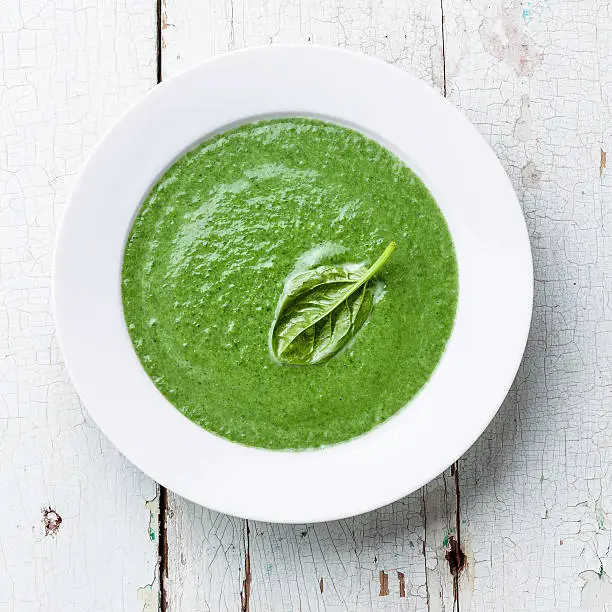 Spinach soup in white bowl