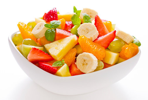 Mixed fruit salad in a white square bowl