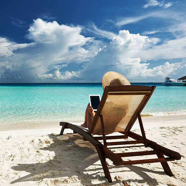 istock Young woman with tablet pc at the beach 177755116