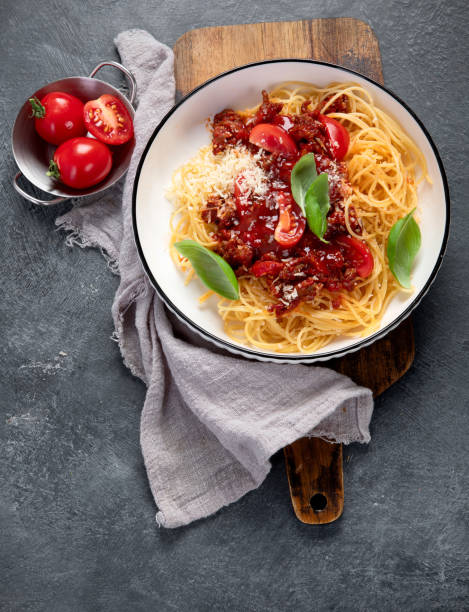 istock Pasta spaghetti bolognese with minced beef sauce, tomatoes, parmesan cheese and fresh basil in a plate. Italian food 1777551638