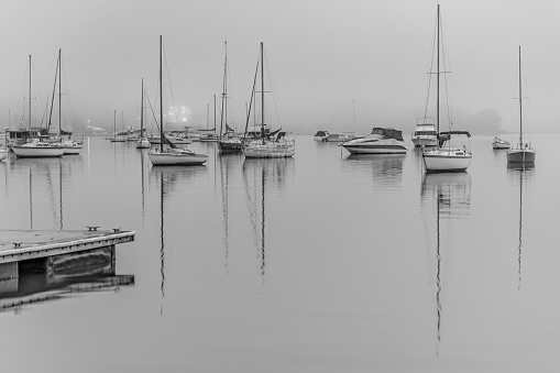 Foggy Sunrise with boats on Brisbane Water at Koolewong and Tascott on the Central Coast, NSW, Australia.