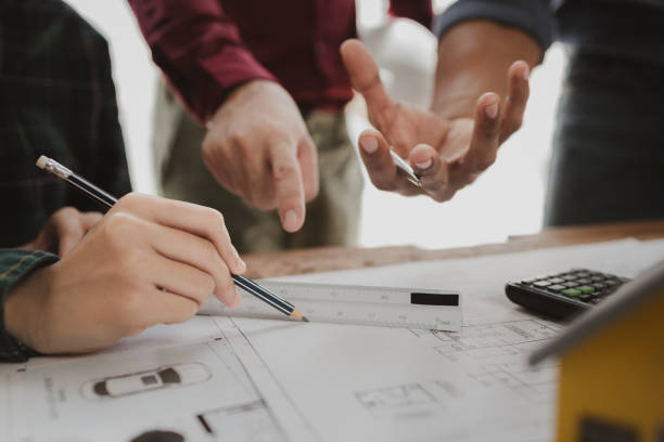 istock Commercial buildings are being evaluated by architects on what type of construction they need to be built,  Engineers are designing a structure according to blueprints. 1777567020