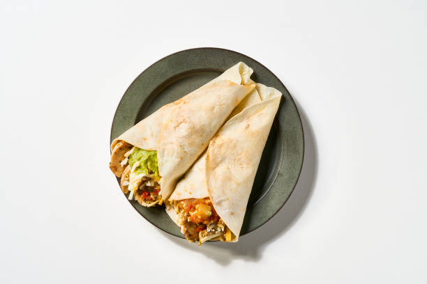 Roasted Chicken Tortilla wrap sandwich on a white background