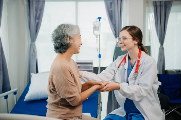 istock Doctor in white suit take notes while discussing and Asian elderly, woman patient who lying on bed with receiving saline solution in hospital or clinic. 1777572601