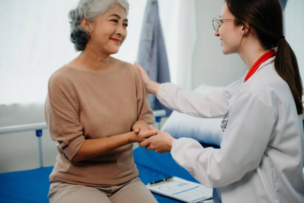 istock Doctor in white suit take notes while discussing and Asian elderly, woman patient who lying on bed with receiving saline solution in hospital or clinic. 1777572613