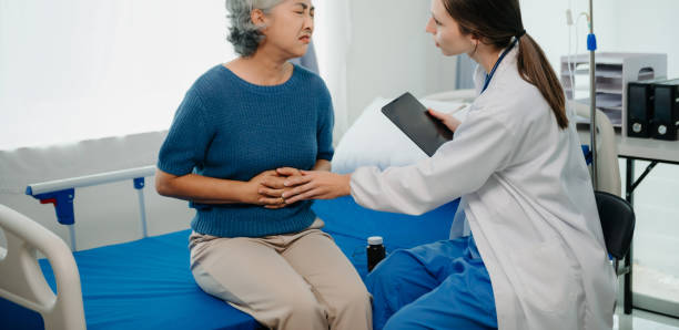istock Doctor in white suit take notes while discussing and Asian elderly, woman patient who lying on bed with receiving saline solution in hospital or clinic. 1777572616
