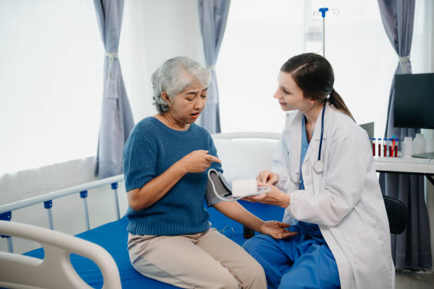 istock Doctor in white suit take notes while discussing and Asian elderly, woman patient who lying on bed with receiving saline solution in hospital or clinic. 1777572624