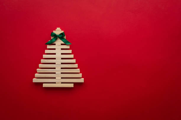 istock symbol Christmas tree from a wooden sticks on red background. Empty copy space for your greetings 1777573711
