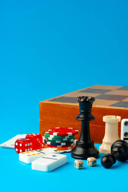 istock Items for playing chess, poker and domino on blue background studio shot 1777579082