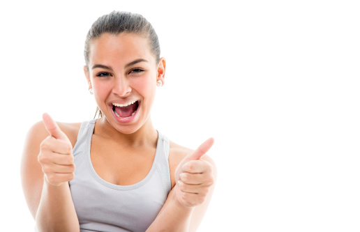 Portrait of a happy girl smiling with thumbs up. Isolated over white background