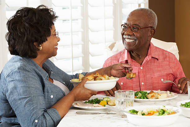 istock A senior couple sitting at a dinner table eating 177758614