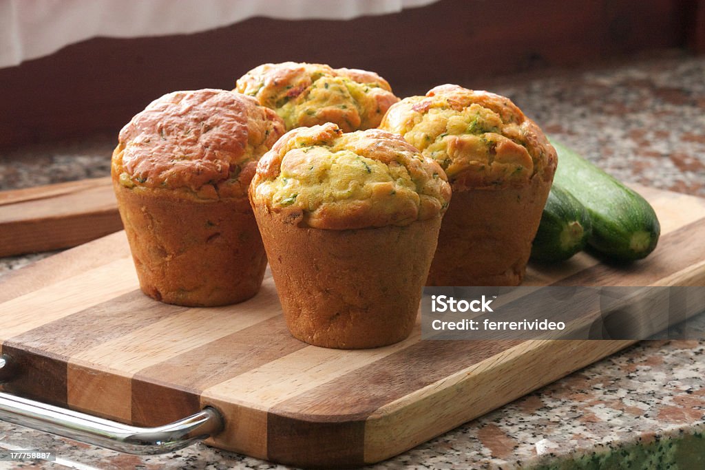 4 muffins made out of zucchini on a wooden board zucchini muffin Muffin Stock Photo