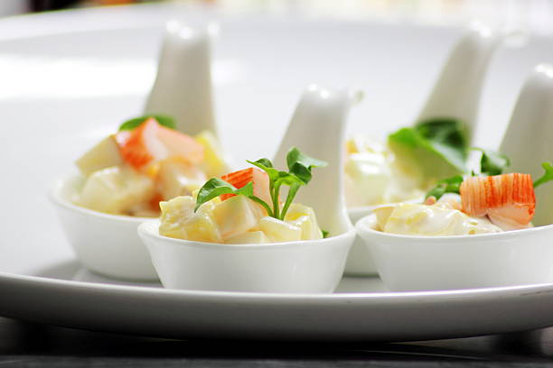 potato salad in white spoon and green vegetable