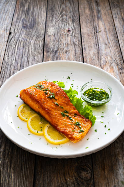 istock Seared salmon with fresh vegetables on wooden table 1777591919
