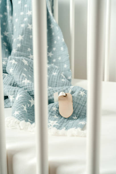 istock Soft blue muslin blanket hanging on a baby's bed 1777607023