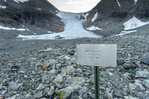 Melting  Steindalsbreen Glacier in the Steindalen Valley. The sign is located where the edge of the glacier was in August 5 1998.  Lyngen Alps, Northern Norway