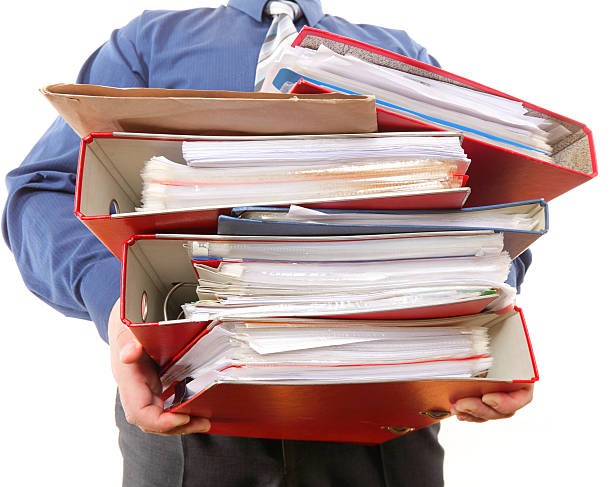 istock Male office worker carrying a stack of files 177762304