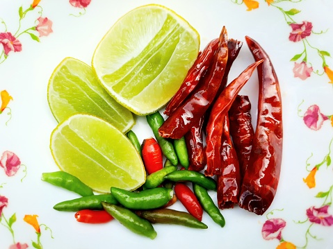 Various spices in spoon, chilli, garlic, copy space, black background.