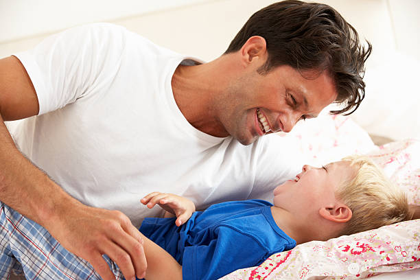 istock Father And Son Relaxing Together In Bed 177762773
