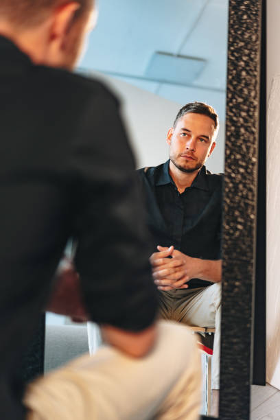 istock Young man looking at himself in the mirror 1777631507