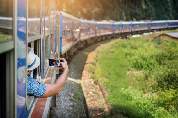 istock Man tourist using mobile phone taking photo of rail way 1777641894