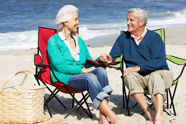 istock Senior Couple Sitting On Beach In Deckchairs Having Picnic 177764207