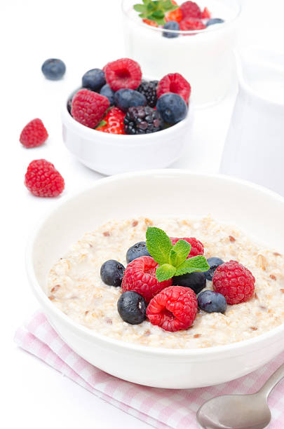 istock healthy breakfast - oatmeal with fresh berries isolated on white 177764466