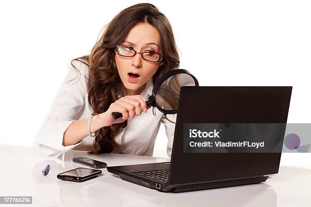 A Younger Businesswoman Uses A Spyglass Stock Photo - Download Image Now - Magnifying Glass, Detective, Women