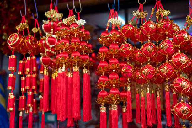 istock A vibrant array of decorations and ornaments for Chinese New Year, symbolizing luck, healthiness, happiness, reunion, and prosperity, is on display at a market stall for sale. 1777653881