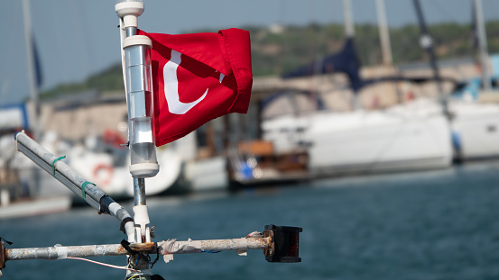 Turkish flag on pole on boat in  Sığacık Teos marin. Seferihisar, Izmir, Aegean Turkey