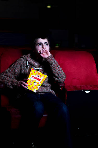 istock Watching a film and eating popcorn 177766326
