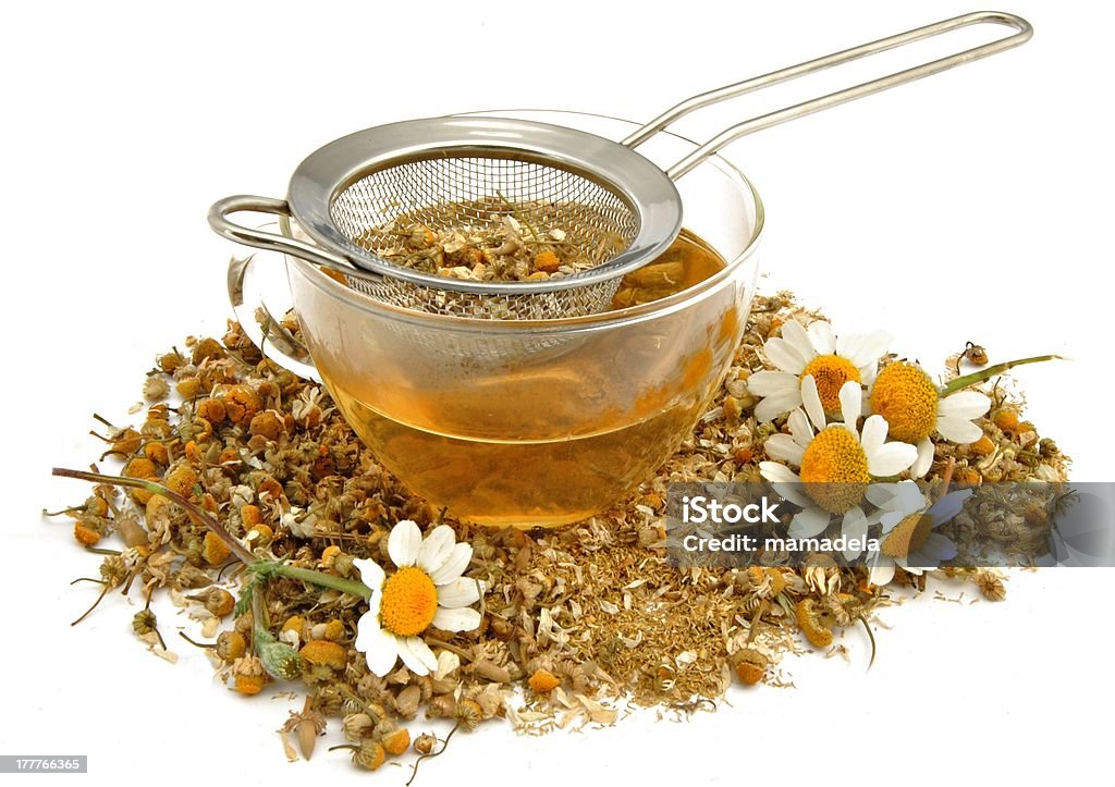 Cup with chamomile Cup with chamomile surrounded by white background Chamomile Plant Stock Photo