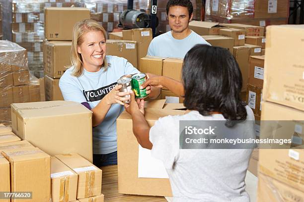 Volunteers Collecting Food Donations In A Warehouse Stock Photo - Download Image Now