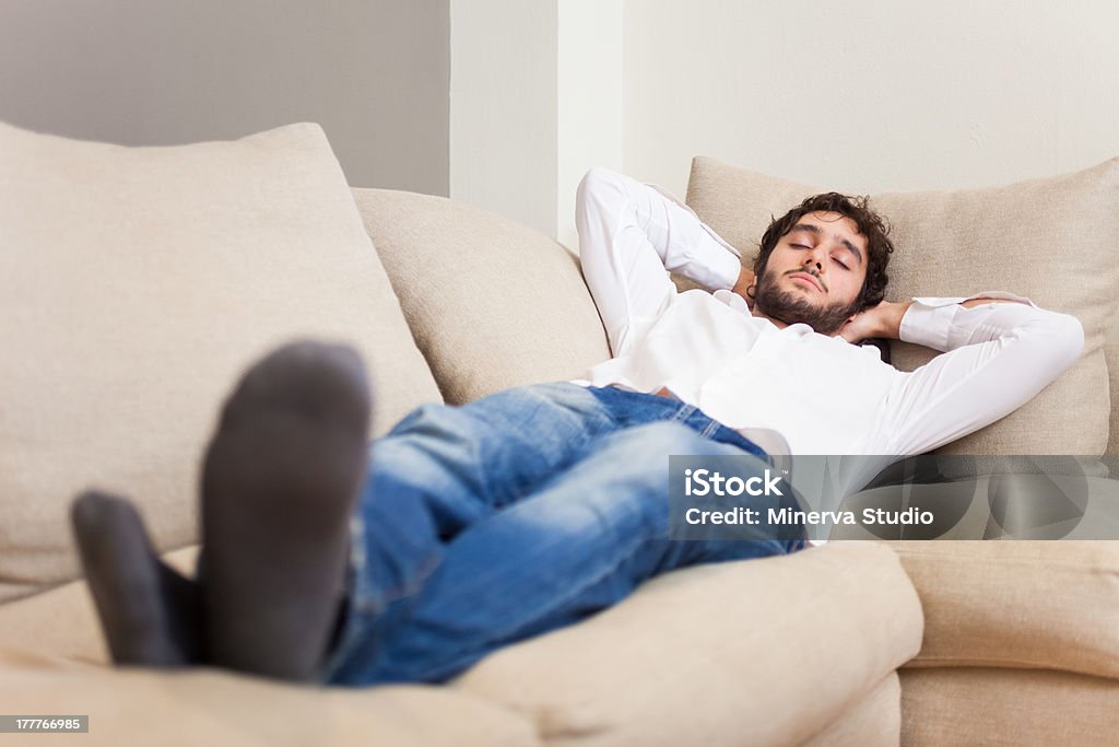 Man sleeping on his couch Young man sleeping on his couch Adult Stock Photo