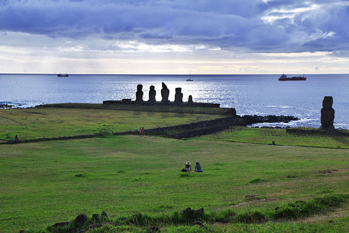 Easter Island, Chile - 27 Dec 2019: Rapa Nui, sunset, the statue Moai in Ahu Tahai on Easter Island, Chile