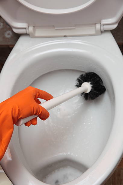 istock Gloved hand cleaning toilet bowl using brush 177768908