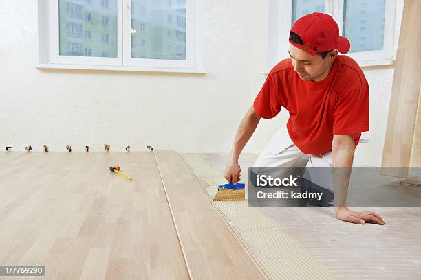 Parquet Worker Adding Glue On Floor Stock Photo - Download Image Now - Adult, Anaerobic Exercise, Blue-collar Worker