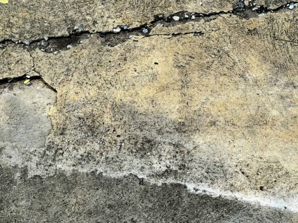 a close up of a concrete floor with a crack.