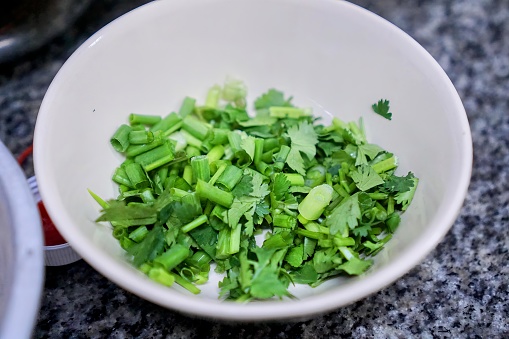 chopped green onions in a bowl.