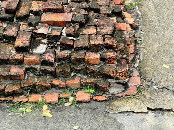 istock a broken brick wall in the street. 1777697616